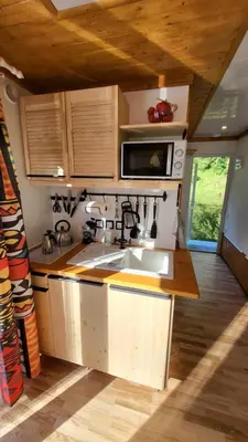a kitchen with a sink and a microwave at Houseboat Vilnius in Vilnius