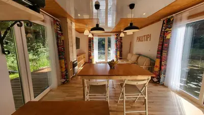 a dining room with a large wooden table and chairs at Houseboat Vilnius in Vilnius