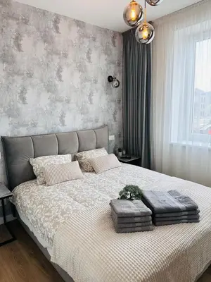 a bedroom with a large bed with two pillows at Stylish Apartment 5 min from Kaunas Clinics in Kaunas