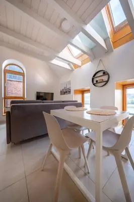 a living room with a table and chairs and a couch at King Mindaugas Apartments in Kaunas