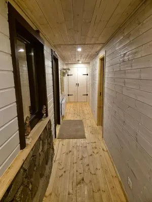 a hallway of a house with a door and a rug at Kaimo turizmo sodyba Kukarskė in Kiduliai