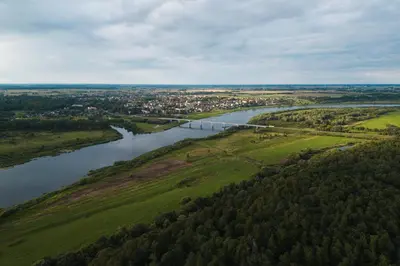 an aerial view of a river and a city at Kaimo turizmo sodyba Kukarskė in Kiduliai