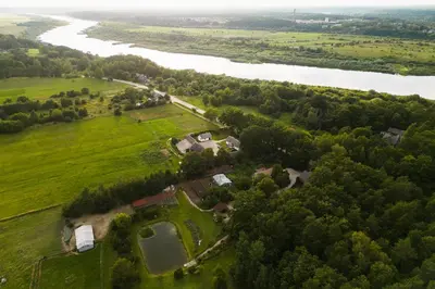 an aerial view of a park next to a river at Kaimo turizmo sodyba Kukarskė in Kiduliai