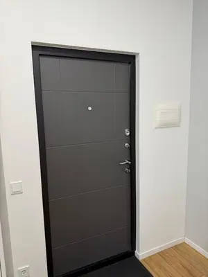 a black door in a room with a white wall at poilsio ramybes oaze in VNO
