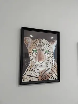 a picture of a leopard in a frame on a wall at poilsio ramybes oaze in VNO