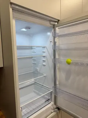 an empty refrigerator with a tennis ball in it at poilsio ramybes oaze in VNO