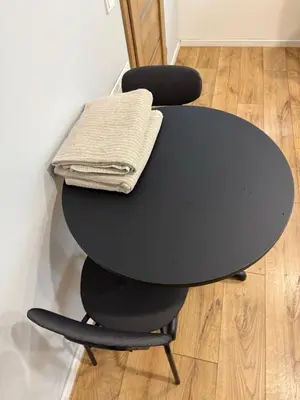 a black table with two chairs with a towel on it at poilsio ramybes oaze in VNO