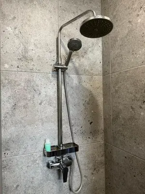 a shower with a shower head in a bathroom at poilsio ramybes oaze in VNO