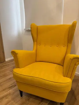 a yellow chair sitting in a room at poilsio ramybes oaze in VNO