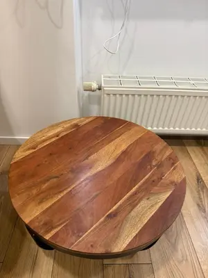 a wooden table sitting on the floor in a room at poilsio ramybes oaze in VNO