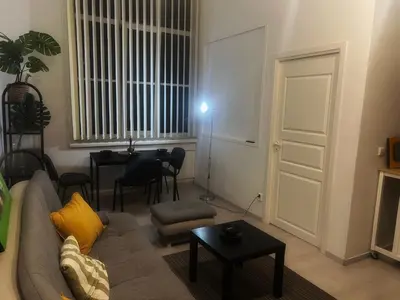 a living room with a couch and a table at Tech City Apartments, Nr Vilnius Old Town in Vilnius