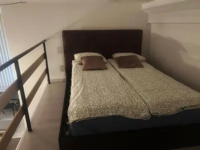 a bed with two pillows on it in a bedroom at Tech City Apartments, Nr Vilnius Old Town in Vilnius