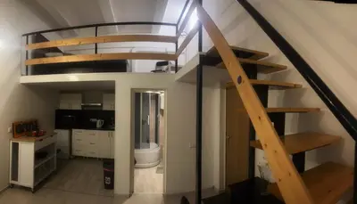 a staircase in a room with a kitchen and a bathroom at Tech City Apartments, Nr Vilnius Old Town in Vilnius