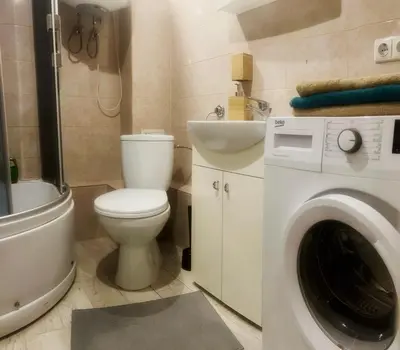 a bathroom with a toilet and a washing machine at Tech City Apartments, Nr Vilnius Old Town in Vilnius