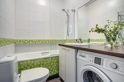 a bathroom with a washing machine and a sink at Domillion Quiet 2bdr apt w panorama & balcony B83 in Vilnius