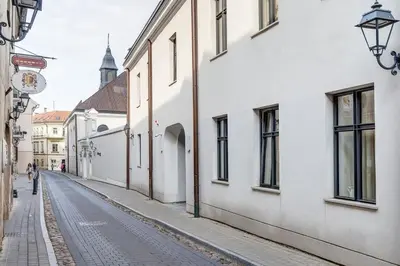 an empty street in a city with white buildings at Domillion Quiet 2bdr apt w panorama & balcony B83 in Vilnius