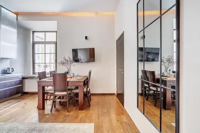a kitchen and dining room with a table and chairs at Domillion Quiet 2bdr apt w panorama & balcony B83 in Vilnius