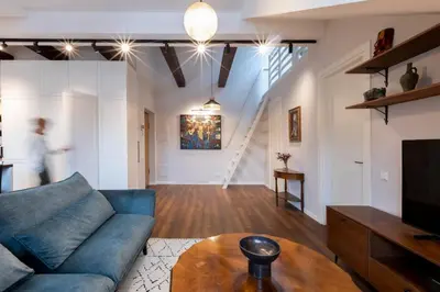 a living room with a blue couch and a table at Domillion 2bdr old town apt at Bazilijonai in Vilnius