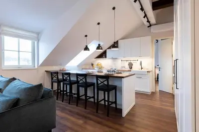 a kitchen with a large island in a living room at Domillion 2bdr old town apt at Bazilijonai in Vilnius