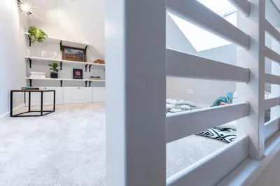 a bedroom with white walls and white shelves at Domillion 2bdr old town apt at Bazilijonai in Vilnius