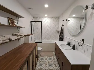 a bathroom with a tub and a sink and a mirror at Domillion 2bdr old town apt at Bazilijonai in Vilnius