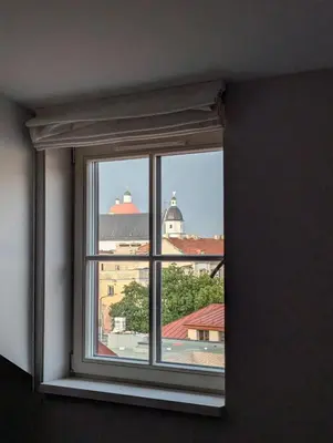 a window in a room with a view of a building at Domillion 2bdr old town apt at Bazilijonai in Vilnius