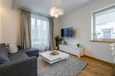 a living room with a couch and a coffee table at Domillion 1bdr lovely apt with parking &lift B9a4 in Vilnius