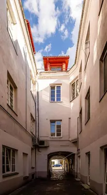 a building with a red window on top of it at Domillion New City Hall Duplex D11C for 12 ppl in Vilnius
