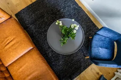 a plate with flowers on top of a table at Domillion New City Hall Duplex D11C for 12 ppl in Vilnius