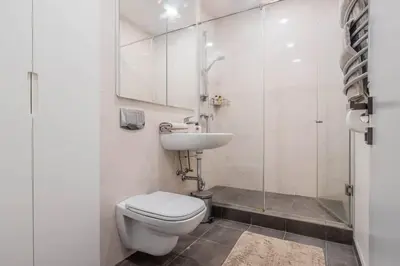 a bathroom with a toilet and a sink at Domillion New City Hall Duplex D11C for 12 ppl in Vilnius