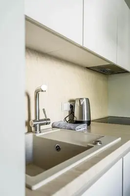 a kitchen counter with a sink in a kitchen at Domillion New City Hall Duplex D11C for 12 ppl in Vilnius