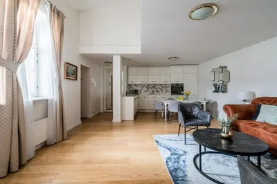 a living room with a couch and a table at Domillion 3bdr Huge Town Hall Luxury Apt AC D3948 in Vilnius