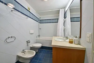 a bathroom with a sink and a toilet and a mirror at Domillion 3bdr Huge Town Hall Luxury Apt AC D3948 in Vilnius