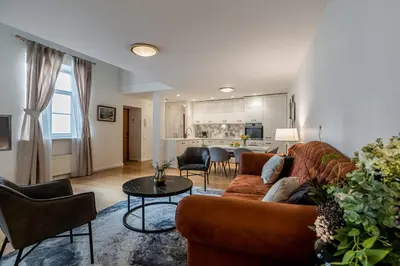 a living room with a couch and a table at Domillion 3bdr Huge Town Hall Luxury Apt AC D3948 in Vilnius