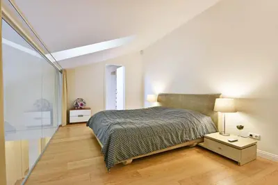 a bedroom with a bed in a white room at Domillion 3bdr Huge Town Hall Luxury Apt AC D3948 in Vilnius