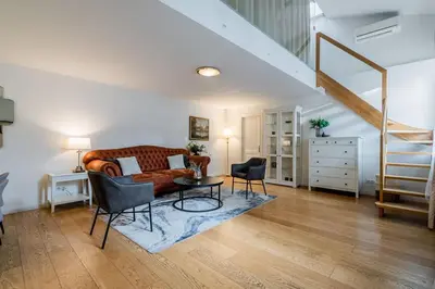 a living room with a couch and a table at Domillion 3bdr Huge Town Hall Luxury Apt AC D3948 in Vilnius