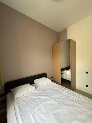 a bedroom with a large white bed and a mirror at Domillion 2bdr new apt on Pilies st in Vilnius