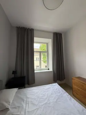 a bedroom with a white bed and a window at Domillion 2bdr new apt on Pilies st in Vilnius