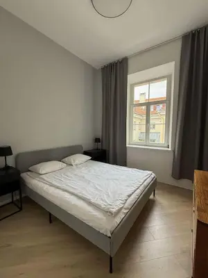 a bedroom with a bed and a window at Domillion 2bdr new apt on Pilies st in Vilnius