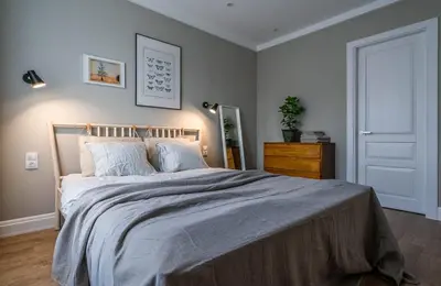 a bedroom with a large bed and a dresser at Domillion New Duplex 12ppl balconies free park N2A in Vilnius