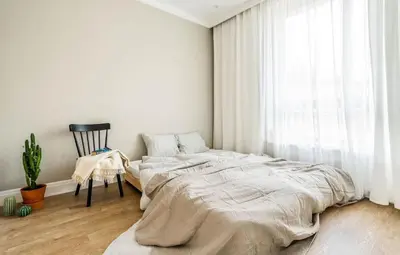 a bedroom with a large bed and a chair at Domillion New Duplex 12ppl balconies free park N2A in Vilnius