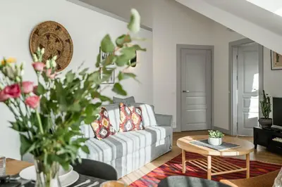 a living room with a couch and a table at Domillion New Duplex 12ppl balconies free park N2A in Vilnius