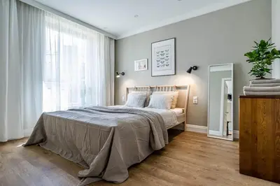 a bedroom with a bed and a large window at Domillion New Duplex 12ppl balconies free park N2A in Vilnius