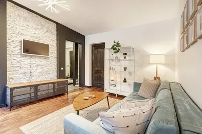 a living room with a couch and a table at Domillion 1bdr Dominikonu str apt Do333 in Vilnius