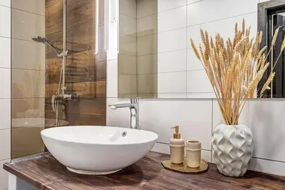 a bathroom with a sink and a vase on a counter at Domillion 1bdr Dominikonu str apt Do333 in Vilnius