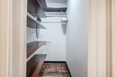 a kitchen with white walls and wooden floors and shelves at Domillion 1bdr Dominikonu str apt Do333 in Vilnius