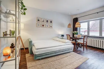 a bedroom with a bed and a table in it at Domillion 1bdr Dominikonu str apt Do333 in Vilnius