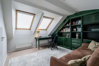 a living room with a couch and a desk at Domillion Amazing 3bdr Penthouse with Terrace MZ28 in Vilnius
