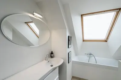 a white bathroom with a sink and a mirror at Domillion Amazing 3bdr Penthouse with Terrace MZ28 in Vilnius