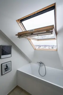 a skylight in a bathroom with a sink and a window at Domillion Amazing 3bdr Penthouse with Terrace MZ28 in Vilnius